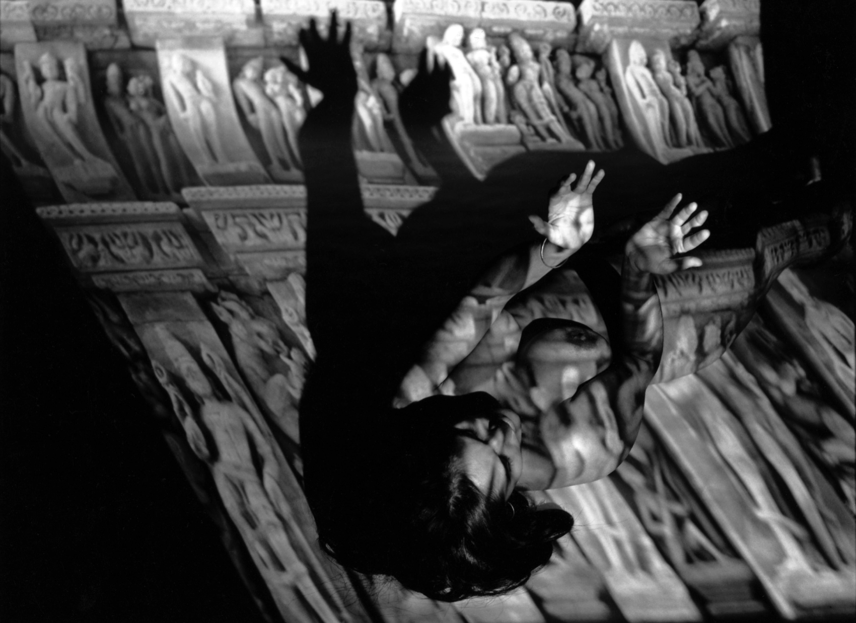 Synapse IV - Figure with arms raised against sculptural relief projections